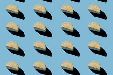 Collection of tasty marshmallows with hard shadows on a light blue background.