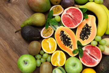 Various fruits on wooden background. Summer concept. Flat lay, top view.