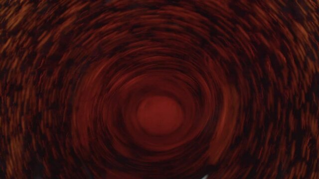 Close up swirl in a dark liquid. Whirlpool in the cola or dark beer mixing by stirrer. Abstract circle motion background with gold reflections