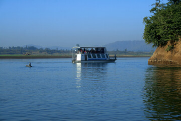 Fototapeta na wymiar Small cruise boat with beautiful landscape at Narmada River.