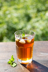 iced tea in a glass on a background of nature
