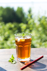 iced tea in a glass on a background of nature