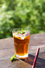 iced tea in a glass on a background of nature