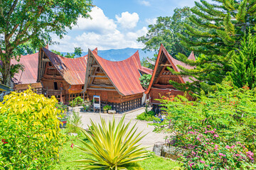 Batak traditional houses in a row at Ambarita village, lake Toba, travel destination in Sumatra, Indonesia. - obrazy, fototapety, plakaty