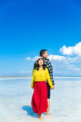 A couple frolicking in a lake in the sea.