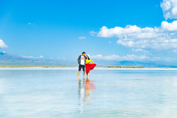 A couple frolicking in a lake in the sea.