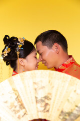 Male and female models in traditional Chinese wedding costumes.