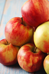 Several ripe red apples on the wooden table