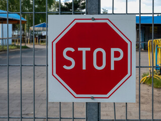stop sign hanging on the entrance gate