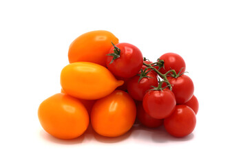 Several red and yellow ripe tomatoes on a light background. Natural product. Natural color. Close-up.