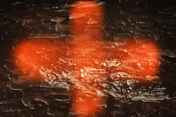 Red cross, bloody sign. Abstract dark brown background.