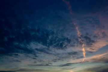 Fototapeta na wymiar Dark evening sky with a light line of clouds. Natural background.