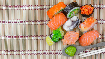 Shushi Japanese Food and salad roll on wooden table.Sushi rolls with salmon, soy sauce and chopsticks