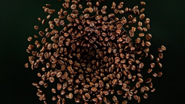 Coffee beans explosion, super slow motion, top view.
