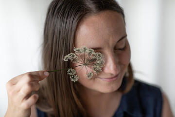 Florist nerd dries and harvests plants. The girl at work in the workshop of the flower shop.