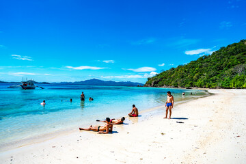 Fototapeta na wymiar Coron, Philippines - January 3, 2020: People relaxing on Malcapuya Island, Coron, Philippines.