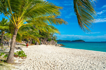 Coron, Philippines - January 3, 2020: People relaxing on Malcapuya Island, Coron, Philippines.