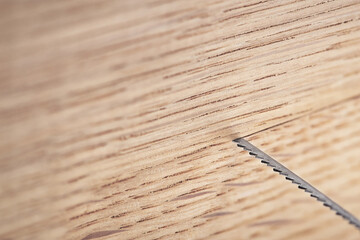 Fret saw cutting wooden oak plank. Jig saw cut clean timber plank.
