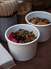 Wholefoods healthy grains, nuts and seeds granola breakfast in rustic natural light setting and custom ceramics