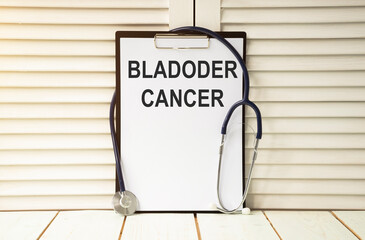 Holding clipboard with bladder cancer text on a sheet of paper on white background