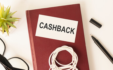 Cashback, text written on a white background on a wooden table. Near Office Supplies