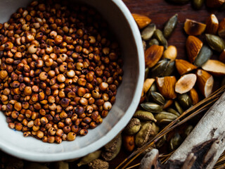 Traditional whole foods, grains, nuts and seeds in rustic, natural light setting with custom made cermics.
