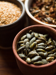 Traditional whole foods, grains, nuts and seeds in rustic, natural light setting with custom made cermics.