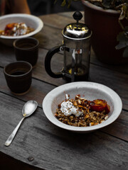 Wholefoods healthy grains, nuts and seeds granola breakfast in rustic natural light setting and custom ceramics