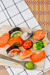 Shushi Japanese Food and salad roll on wooden table.Sushi rolls with salmon, soy sauce and chopsticks