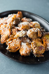 Brussels sprouts shaved and served with crispy bacon and seasoned with olive oil and seasoned with salt and pepper and fresh herbs. Classic American Restaurant appetizer favorite. 