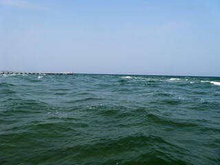 Fototapeta premium Seascape with a pier on the horizon