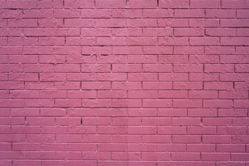 raspberry or purple colored brick wall, textured surface