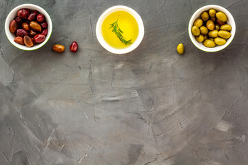 Olive oil in bowl near oilves from above copy space