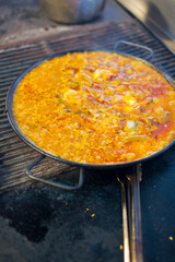 Paella. Traditional classic Spanish seafood dish with fresh seafood, shrimp, mussels, clams, squid cooked in fish broth with saffron and rice garnished with cilantro. 