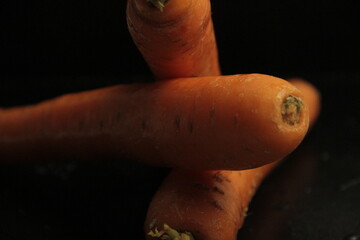 fresh and organic carrots on a black background