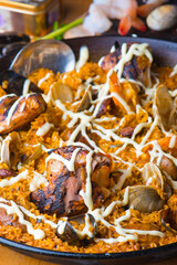 Paella. Traditional classic Spanish seafood dish with fresh seafood, shrimp, mussels, clams, squid cooked in fish broth with saffron and rice garnished with cilantro. 
