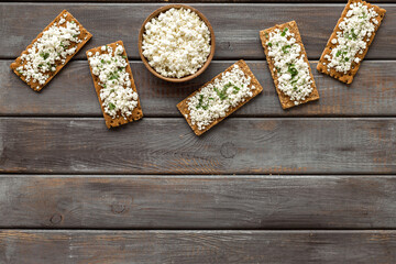 Obraz na płótnie Canvas Cottage cheese toast on wooden desk top view copy space