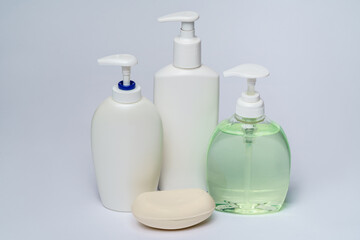 group of hand sanitizer spray and liquid soap bottles isolated on white background
