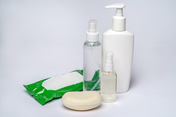 group of hand sanitizer spray or liquid soap bottles over light grey background