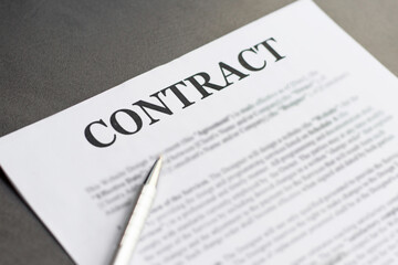 Business Contract and pen close up on grey background