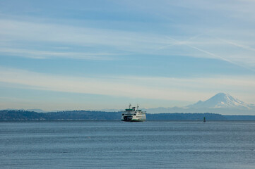 Pacific Northwest scenery with view of Mount Rainier and ferry in Puget Sound