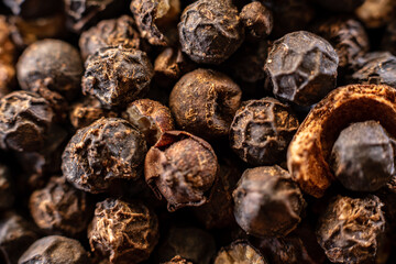 Fullscreen macro closeup with shallow depth of field of unmilled black peppercorns