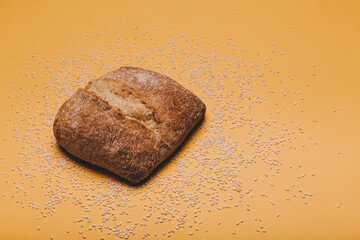 Naklejka premium Cereal bread on yellow bakcground.