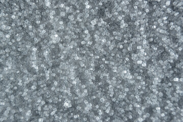 Fullscreen macro closeup with shallow depth of field of small grains of fine salt. Texture. Graphic design.