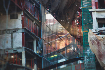 A large construction site in the city, the process of massive skyscraper building construction with heavy vehicle at work © tsuguliev