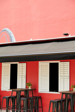 Stylish building of cafe with red walls and white windows