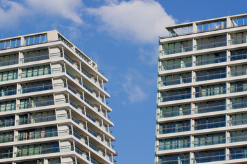 A fragment of the hotel's facade is white against the blue sky.Urban architecture in the minimalism style.