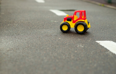 red and yellow toy car on the road