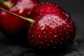 Close up of fresh, healthy and wet sweet cherry berry with water drops on it.