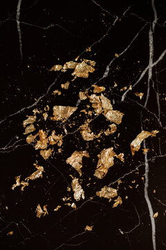gold leaf petals on black marble
